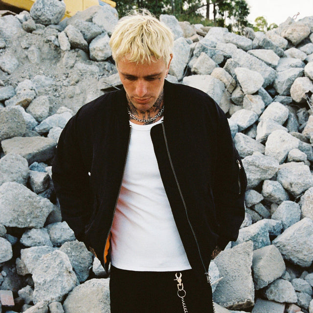 Model wears Gridlock Bomber Jacket Jet Black Jackets in Black - Image 4