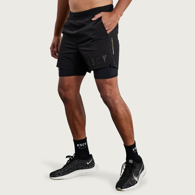 Model wears Hybrid Elasticated Short with Lining Black Shorts in Black - Image 3