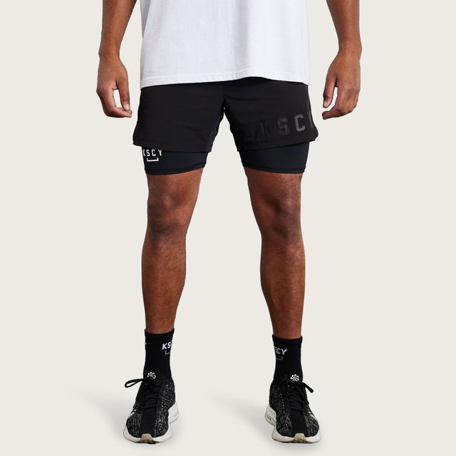 Model wears Hybrid Elasticated Short with Lining Black Shorts in Black - Image 1