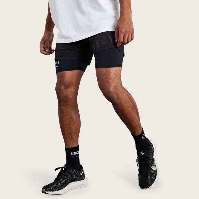 Model wears Hybrid Elasticated Short with Lining Black Shorts in Black - Image 5