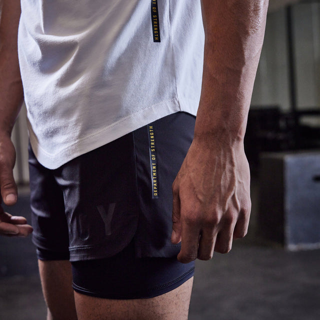 Model wears Hybrid Elasticated Short with Lining Black Shorts in Black - Image 7