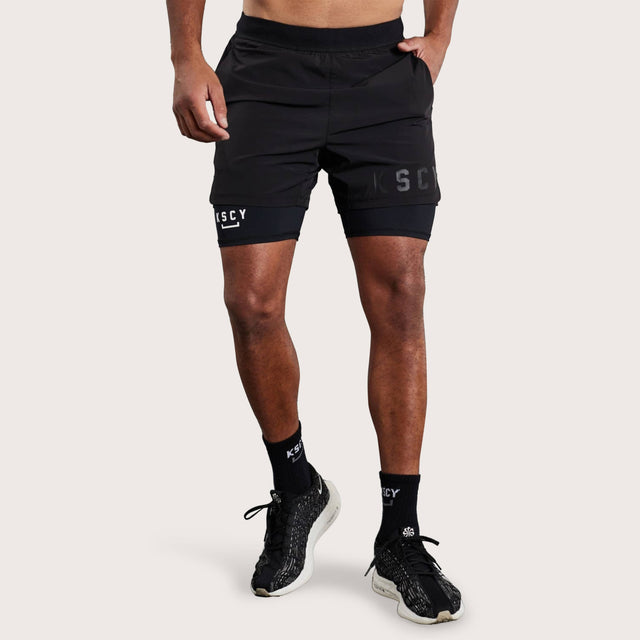 Model wears Hybrid Elasticated Short with Lining Black Shorts in Black - Image 8