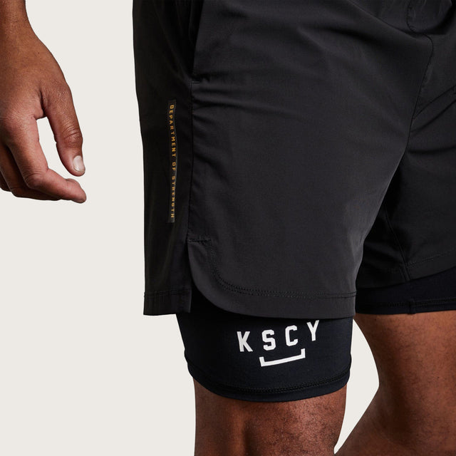 Model wears Hybrid Elasticated Short with Lining Black Shorts in Black - Image 2