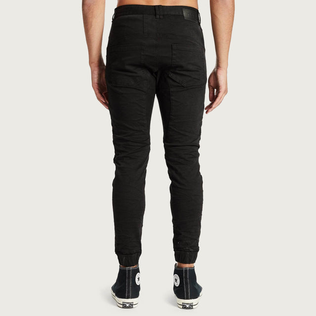 Model wears Hydra Denim Jogger Jet Black Pants in Black - Image 1