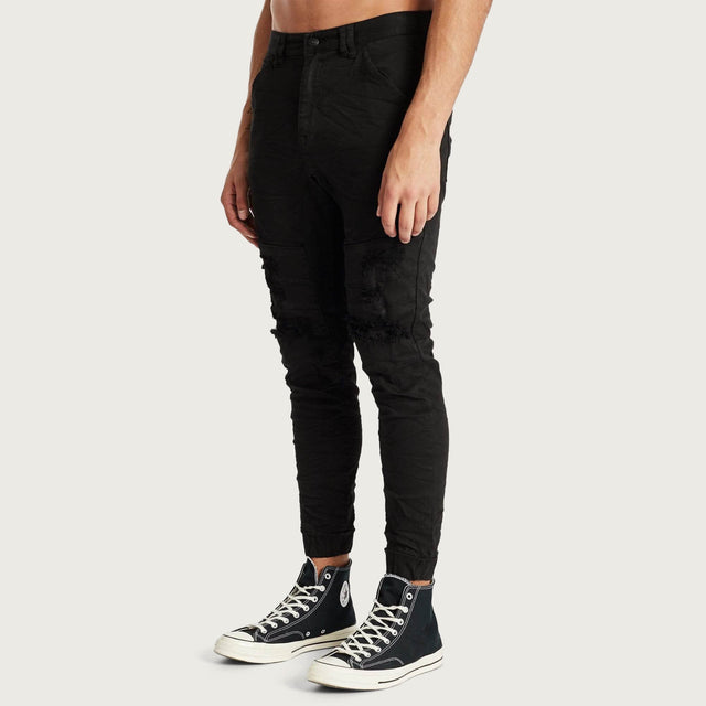 Model wears Hydra Denim Jogger Jet Black Pants in Black - Image 6