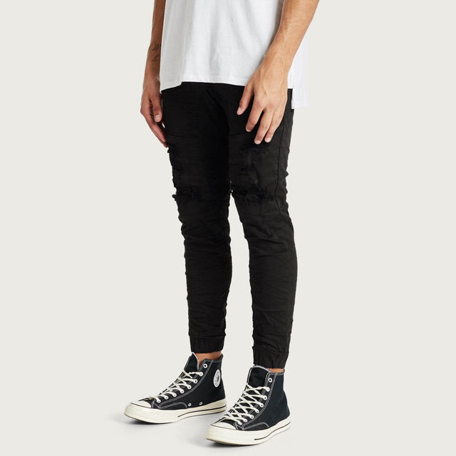 Model wears Hydra Denim Jogger Jet Black Pants in Black - Image 3