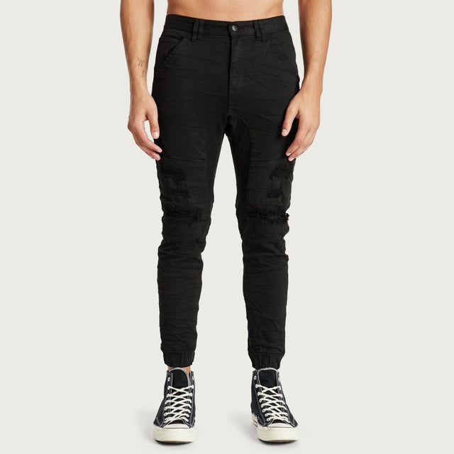 Model wears Hydra Denim Jogger Jet Black Pants in Black - Image 5
