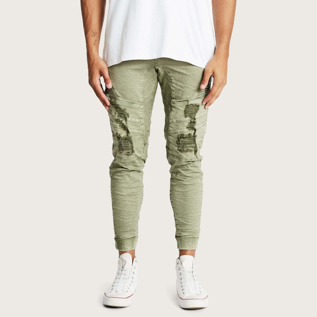 Model wears Hydra Denim Jogger Lichen Green Pants in Green - Image 1