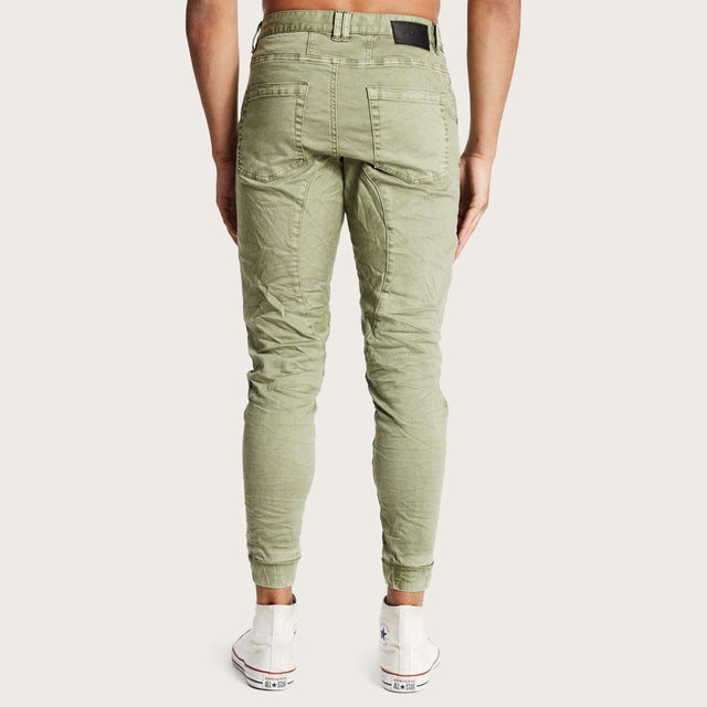 Model wears Hydra Denim Jogger Lichen Green Pants in Green - Image 4