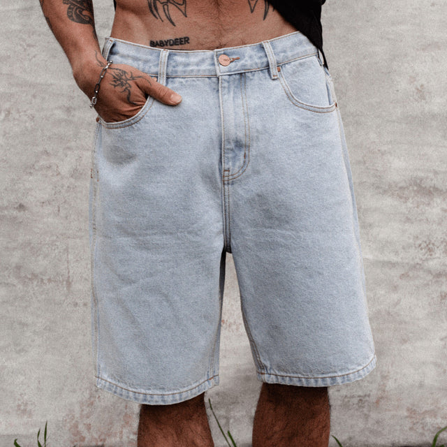 Model wears Hyson Baggy Denim Jorts Light Blue Shorts in Blue - Image 2