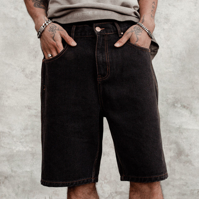 Model wears Hyson Baggy Denim Jorts Washed Black Shorts in Black - Image 2
