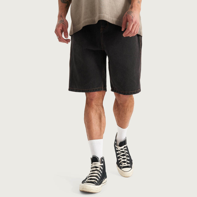 Model wears Hyson Baggy Denim Jorts Washed Black Shorts in Black - Image 1