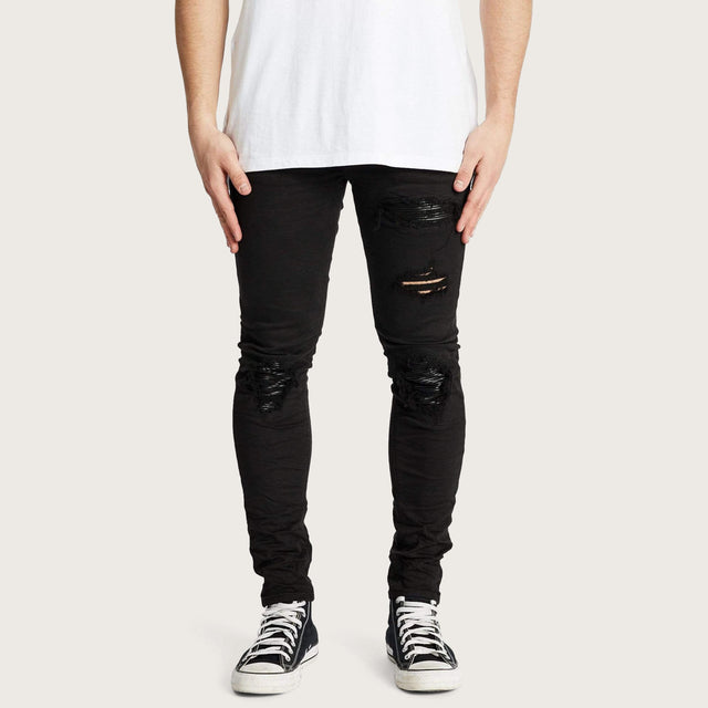 Model wears K1 MX Super Skinny Jeans Jet Black Pants in Black - Image 1