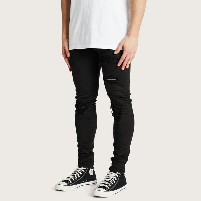 Model wears K1 MX Super Skinny Jeans Jet Black Pants in Black - Image 2