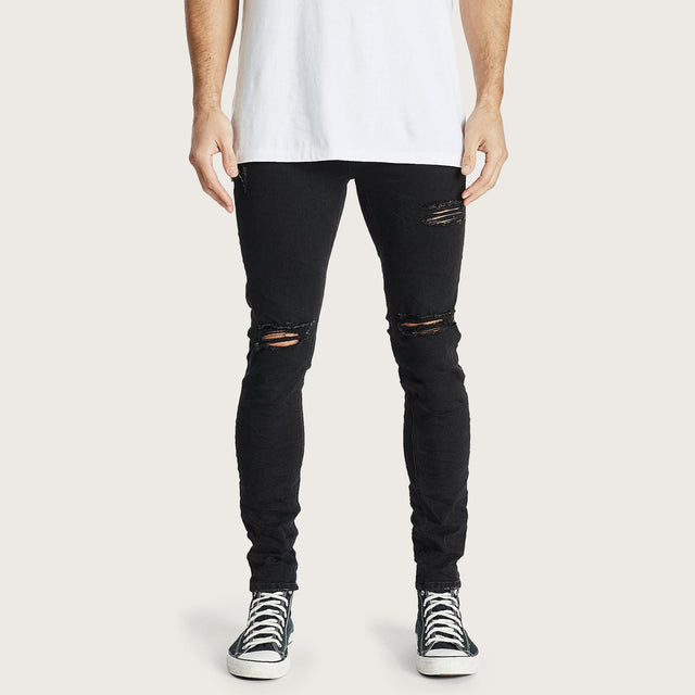 Model wears K1 Super Skinny Fit Jean Destroyed Washed Black Pants in Black - Image 1