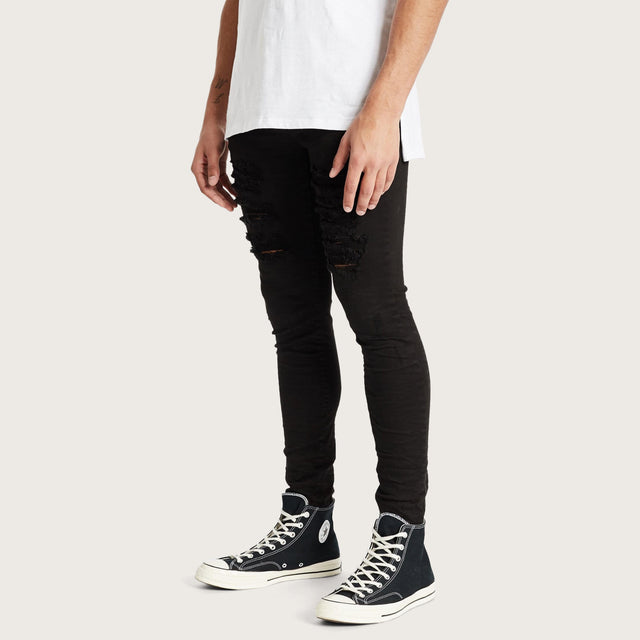 Model wears K1 Super Skinny Jeans Destroyed Black Pants in Black - Image 1