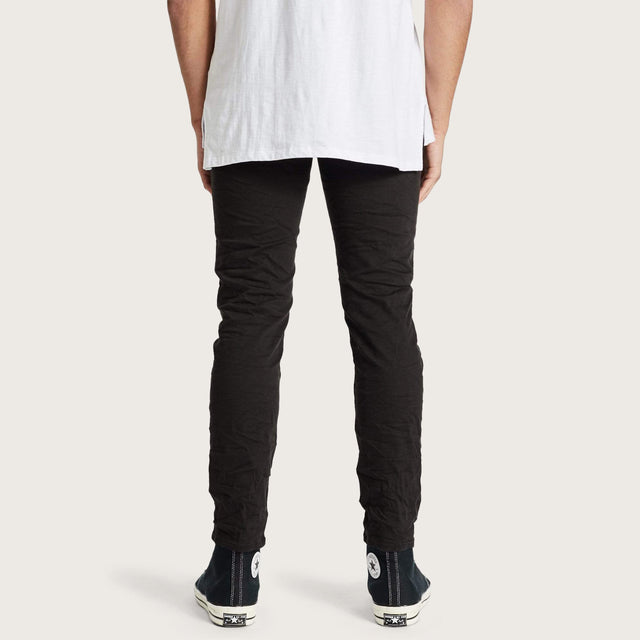 Model wears K2 Skinny Jean Destroyed Black Pants in Black - Image 4