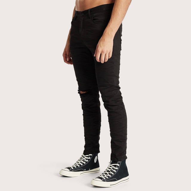 Model wears K2 Skinny Jean Destroyed Black Pants in Black - Image 3