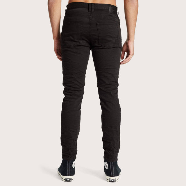 Model wears K2 Skinny Jean Destroyed Black Pants in Black - Image 2