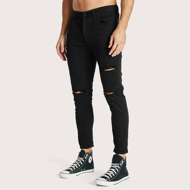 Model wears K4 Cropped Jean Destroyed Black Pants in Black - Image 5