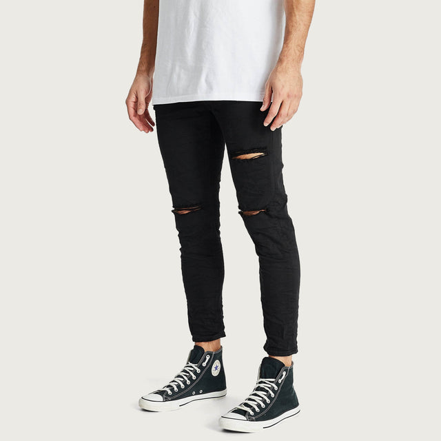 Model wears K4 Cropped Jean Destroyed Black Pants in Black - Image 2