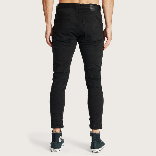 Model wears K4 Cropped Jean Destroyed Black Pants in Black - Image 4