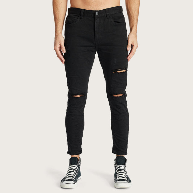 Model wears K4 Cropped Jean Destroyed Black Pants in Black - Image 3