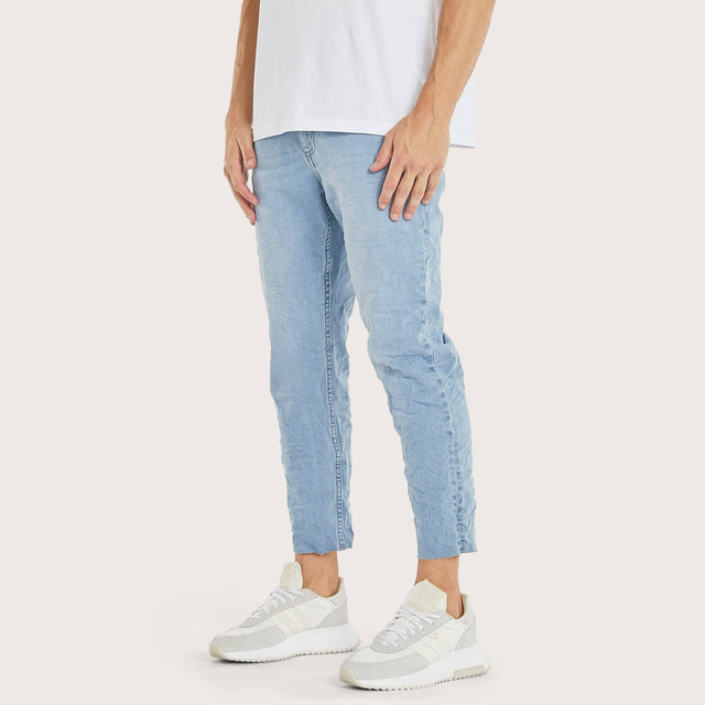 Model wears K5 Slim Cropped Jean Arcade Blue Pants in Blue - Image 1