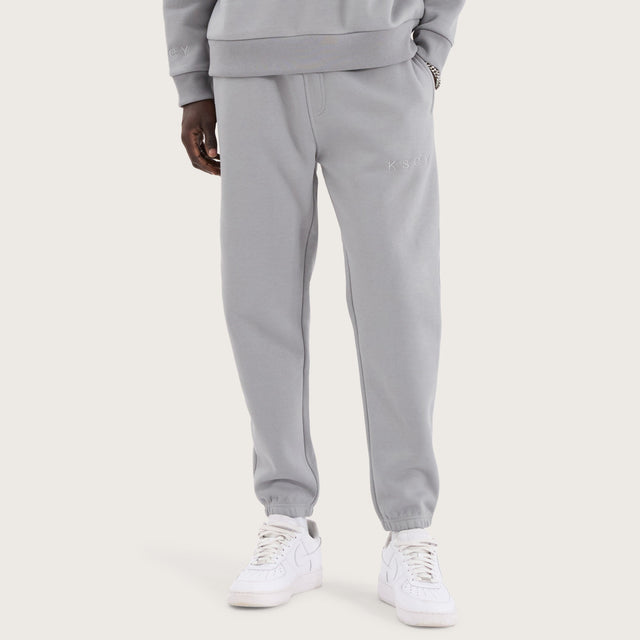 Model wears Kelsey Trackpant Pigment Ultimate Grey Trackpants in Grey - Image 1