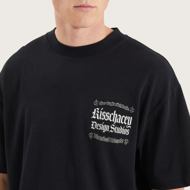 Model wears Machine Street Tee Anthracite Black T-Shirts in Black - Image 6