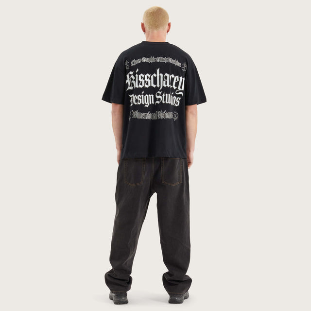 Model wears Machine Street Tee Anthracite Black T-Shirts in Black - Image 9
