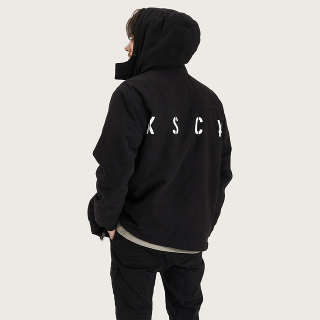 Model wears Maelstrom Parka Jacket Black Jackets in Black - Image 5