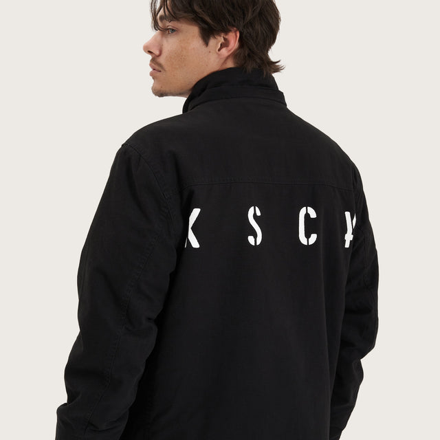 Model wears Maelstrom Parka Jacket Black Jackets in Black - Image 6