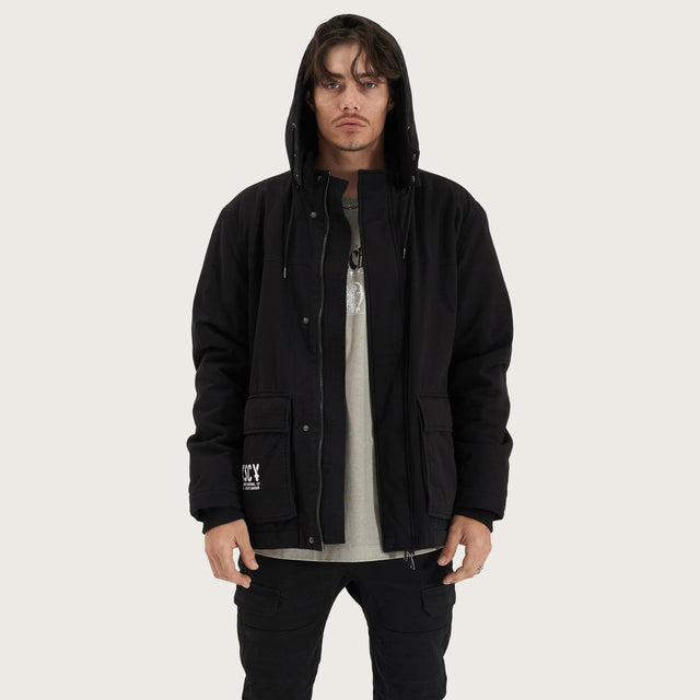 Model wears Maelstrom Parka Jacket Black Jackets in Black - Image 3