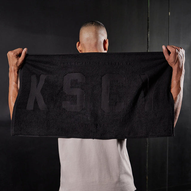 Model wears Motion Gym Towel Black Towels in Black - Image 1