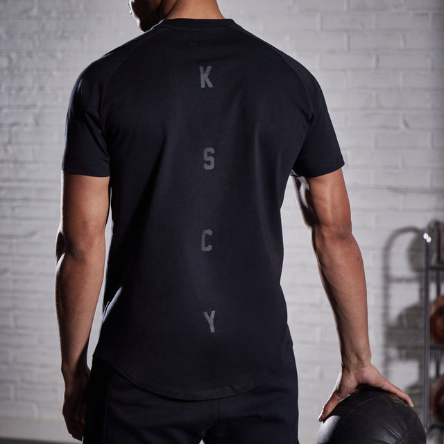 Model wears Process Raglan Curved Hem T-Shirt Jet Black T-Shirts in Black - Image 6