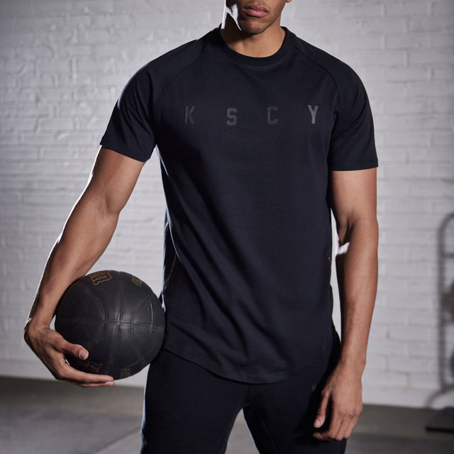 Model wears Process Raglan Curved Hem T-Shirt Jet Black T-Shirts in Black - Image 5