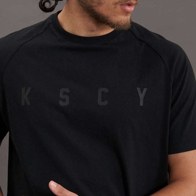 Model wears Process Raglan Curved Hem T-Shirt Jet Black T-Shirts in Black - Image 7