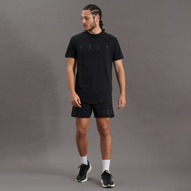 Model wears Process Raglan Curved Hem T-Shirt Jet Black T-Shirts in Black - Image 9