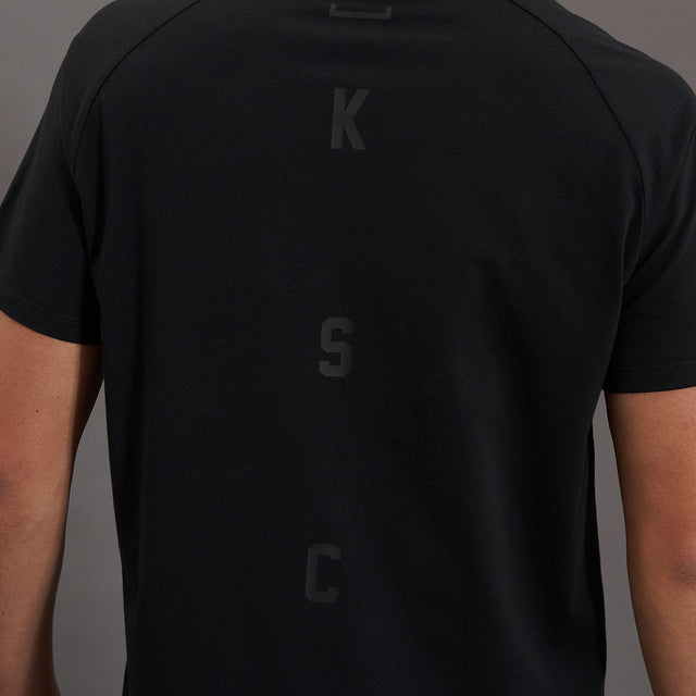Model wears Process Raglan Curved Hem T-Shirt Jet Black T-Shirts in Black - Image 11
