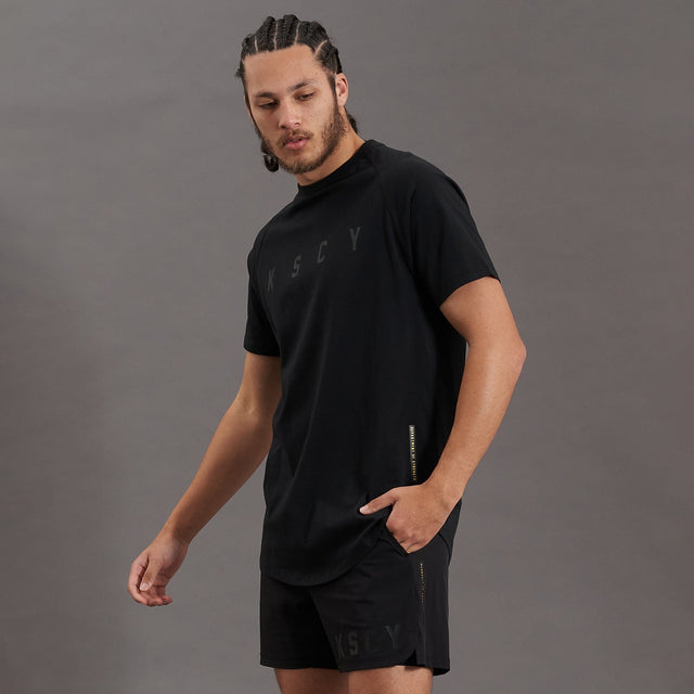 Model wears Process Raglan Curved Hem T-Shirt Jet Black T-Shirts in Black - Image 3