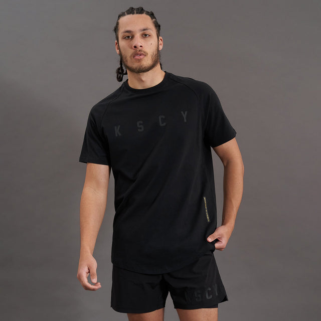 Model wears Process Raglan Curved Hem T-Shirt Jet Black T-Shirts in Black - Image 1
