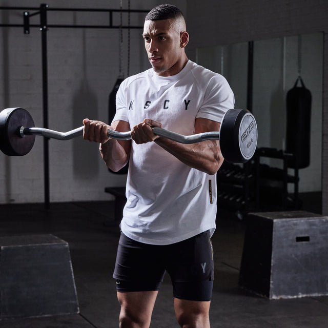 Model wears Process Raglan Curved Hem T-Shirt White T-Shirts in White - Image 2
