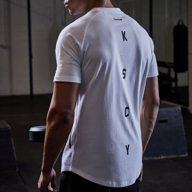 Model wears Process Raglan Curved Hem T-Shirt White T-Shirts in White - Image 5