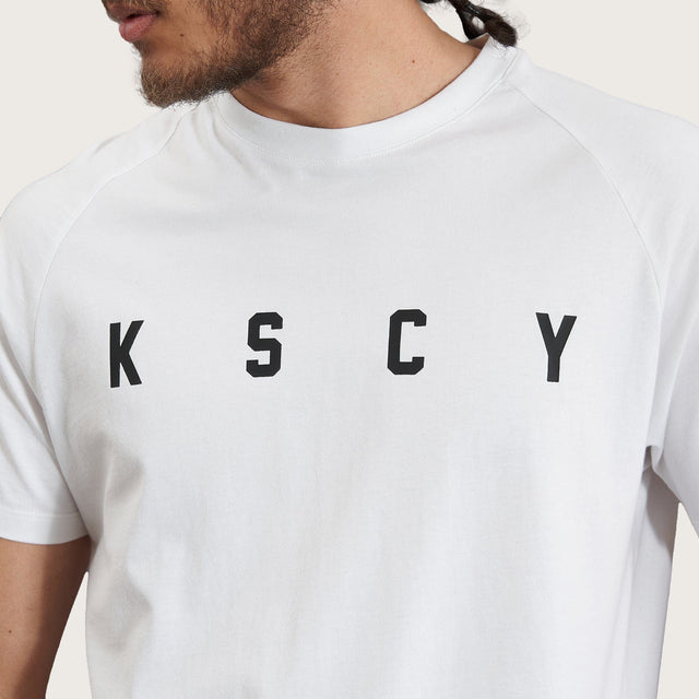 Model wears Process Raglan Curved Hem T-Shirt White T-Shirts in White - Image 6