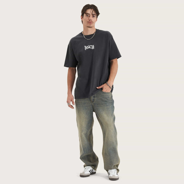 Model wears Tin Petal Heavy Box Fit Tee Pigment Black T-Shirts in Black - Image 4