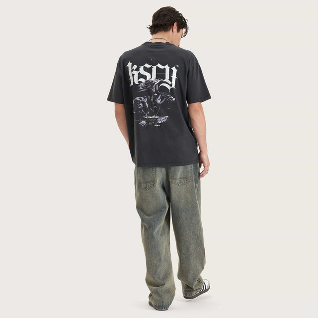 Model wears Tin Petal Heavy Box Fit Tee Pigment Black T-Shirts in Black - Image 3