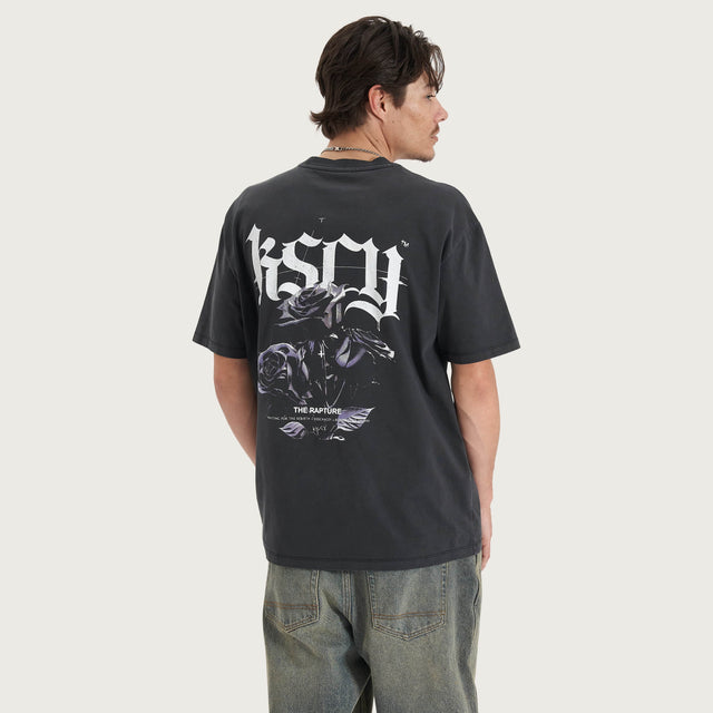 Model wears Tin Petal Heavy Box Fit Tee Pigment Black T-Shirts in Black - Image 1