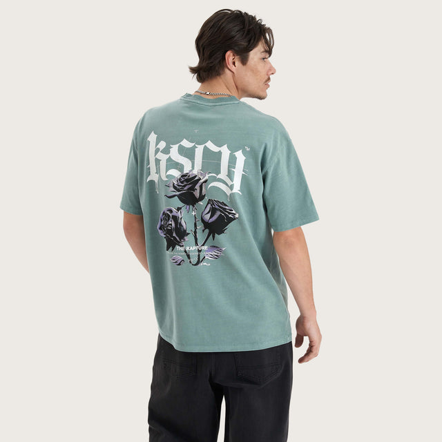 Model wears Tin Petal Heavy Box Fit Tee Pigment Trellis T-Shirts in Green - Image 1