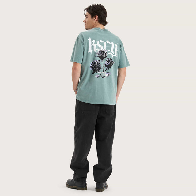 Model wears Tin Petal Heavy Box Fit Tee Pigment Trellis T-Shirts in Green - Image 6